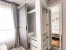 Compact bedroom with built-in wardrobe and air conditioning