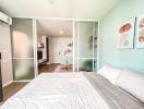 Modern bedroom with a view into the living space and kitchen area