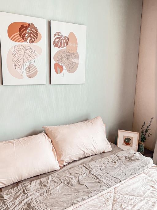 Cozy bedroom with pastel decor and modern wall art