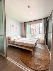 Cozy bedroom with natural light and balcony access