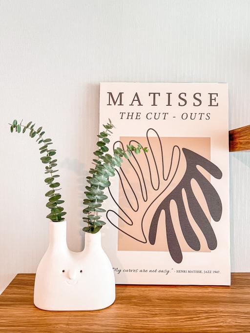 Decorative vase and Matisse art print in an interior space