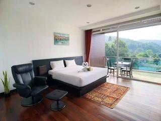 Spacious bedroom with modern furniture and a view