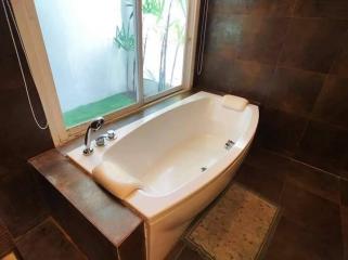 Spacious bathroom with modern bathtub and natural light