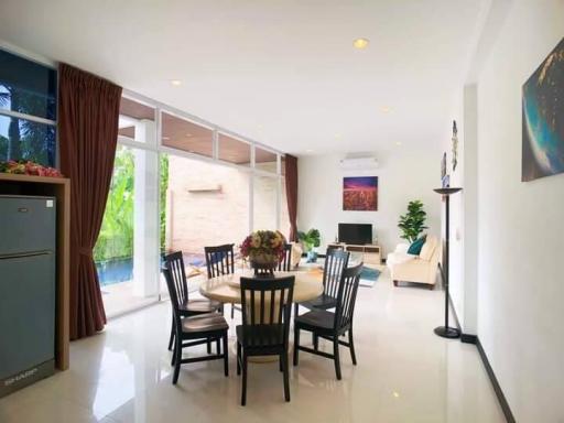 Spacious living room with dining area and natural light