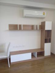 Modern living room with air conditioning and wooden shelving unit