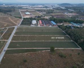 Aerial view of agricultural fields with potential for real estate development near an industrial area