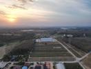 Aerial view of countryside at sunset with roads and buildings