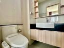 Modern bathroom interior with sleek fixtures and wooden cabinetry