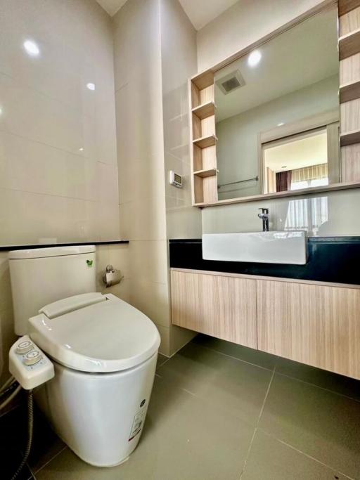 Modern bathroom interior with sleek fixtures and wooden cabinetry