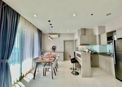 Modern open-plan kitchen with dining area in a bright apartment