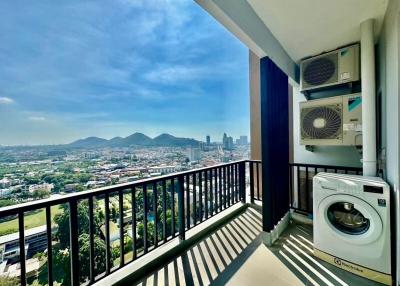 Spacious balcony with a panoramic city view and laundry area