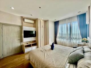 Modern bedroom with large bed and panoramic window