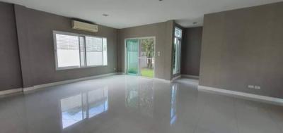 Spacious living room with reflective tile flooring and ample natural light