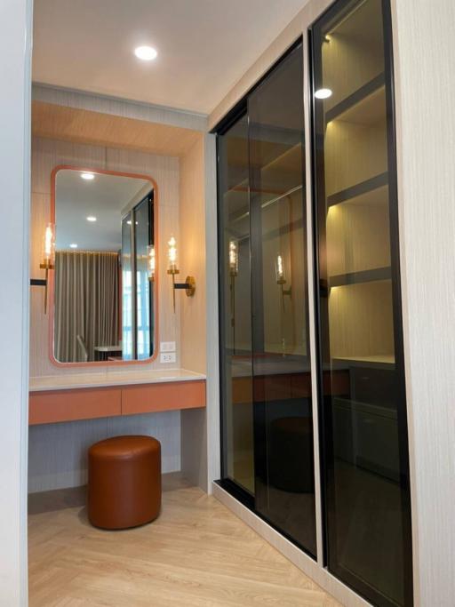 Modern bedroom entry with sliding glass wardrobe and elegant vanity