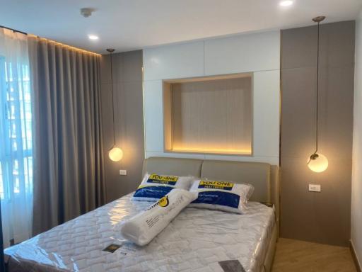 Modern bedroom with a comfortable bed, stylish lighting, and elegant decor