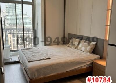 Modern bedroom with large window and city view