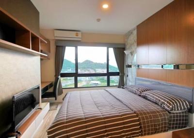 Modern bedroom with a view of the hills