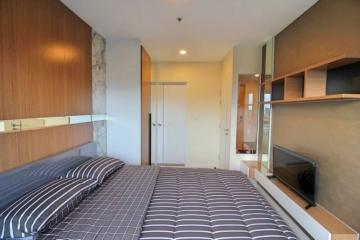 Modern bedroom with comfortable bedding and built-in shelves