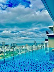 High-rise building rooftop infinity pool with city and ocean view