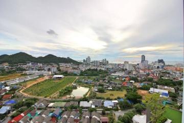 Panoramic view of a vibrant city from a high vantage point with diverse buildings and nature