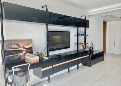 Modern living room interior with large TV and decorative shelving