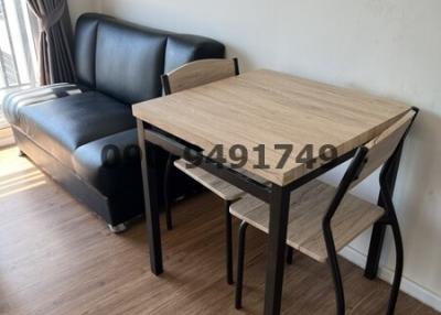 Compact dining area with table and chairs near window