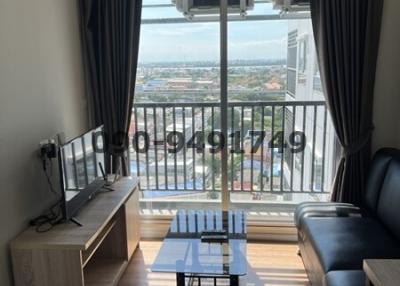 Cozy and well-lit living room with balcony access