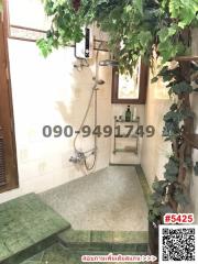 Bright bathroom with greenery and walk-in shower