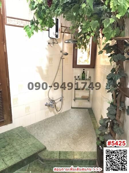 Bright bathroom with greenery and walk-in shower