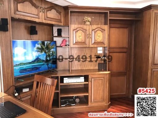 Wooden furnished living room with entertainment system