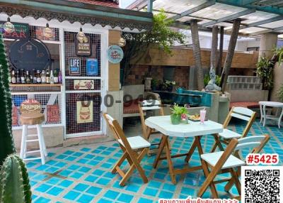 Cozy patio area with distinctive tile flooring and eclectic decor