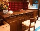 Elegantly furnished wooden kitchen with red backsplash and bar seating