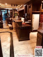 Modern kitchen with marble flooring and dark wood cabinets