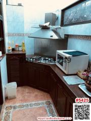 Compact kitchen with dark cabinets and gas stove