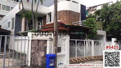 Modern multi-story residential building with unique architecture and gated entrance