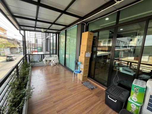 Spacious covered balcony with glass windows and modern flooring