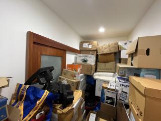 Cluttered room filled with numerous boxes and various items