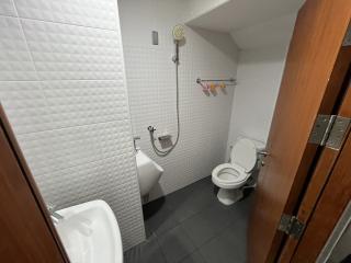 Modern bathroom with white tiles and standard fixtures