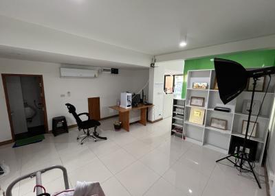Spacious studio office with modern furniture and green screen setup