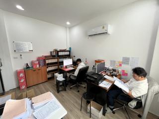 Busy office space with staff working and organizing papers