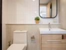 Modern bathroom with white tiles and wooden vanity