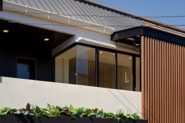 Contemporary house exterior with a clear view of the patio and sliding glass doors