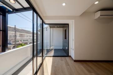 Modern bedroom with large windows and balcony access