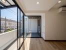 Modern bedroom with large windows and balcony access