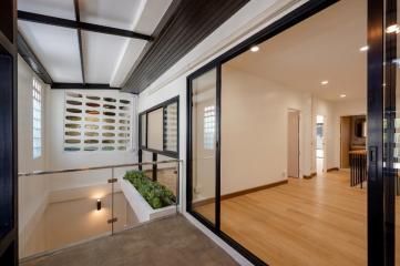 Modern house interior with open space, natural light, and a view into adjacent rooms