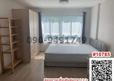 Spacious bedroom with large bed and shelving unit