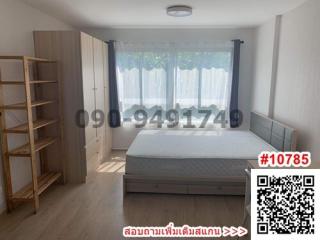 Spacious bedroom with large bed and shelving unit