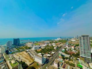 Aerial view of a coastal cityscape with residential and commercial buildings