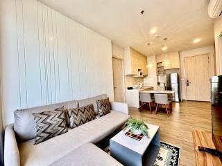 Modern living room with open-plan kitchen and dining area