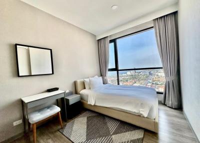 Modern bedroom with city view through large window